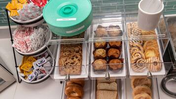 A bakery display with various baked goods including tortillas, muffins, pastries, and bread.