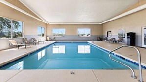 An indoor swimming pool with clear blue water, surrounded by lounge chairs and a tiled deck. - Best Western Snowflake Inn (Snowflake)
