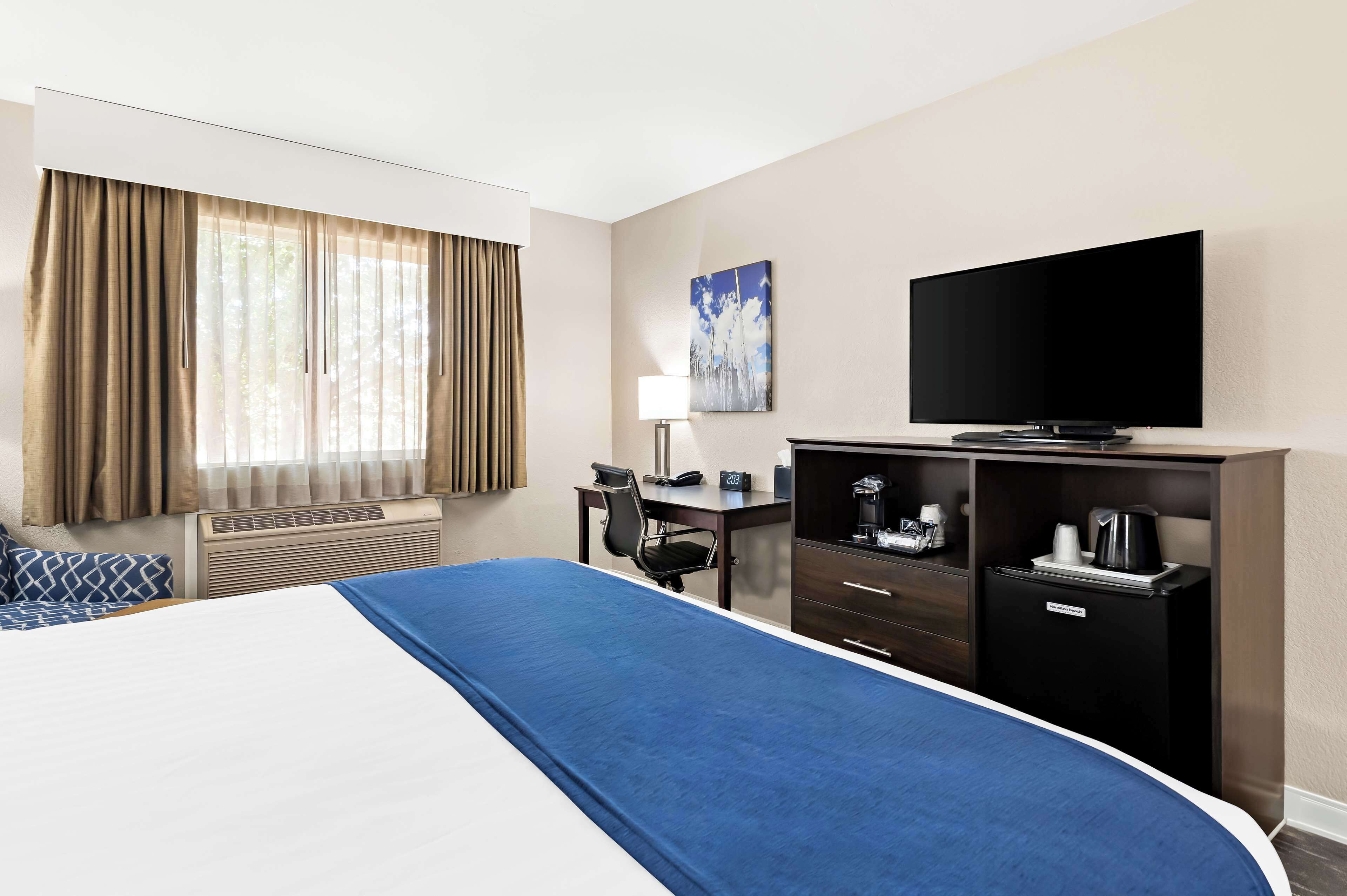 desk, laptop workspace, blackout curtains, iron/ironing board