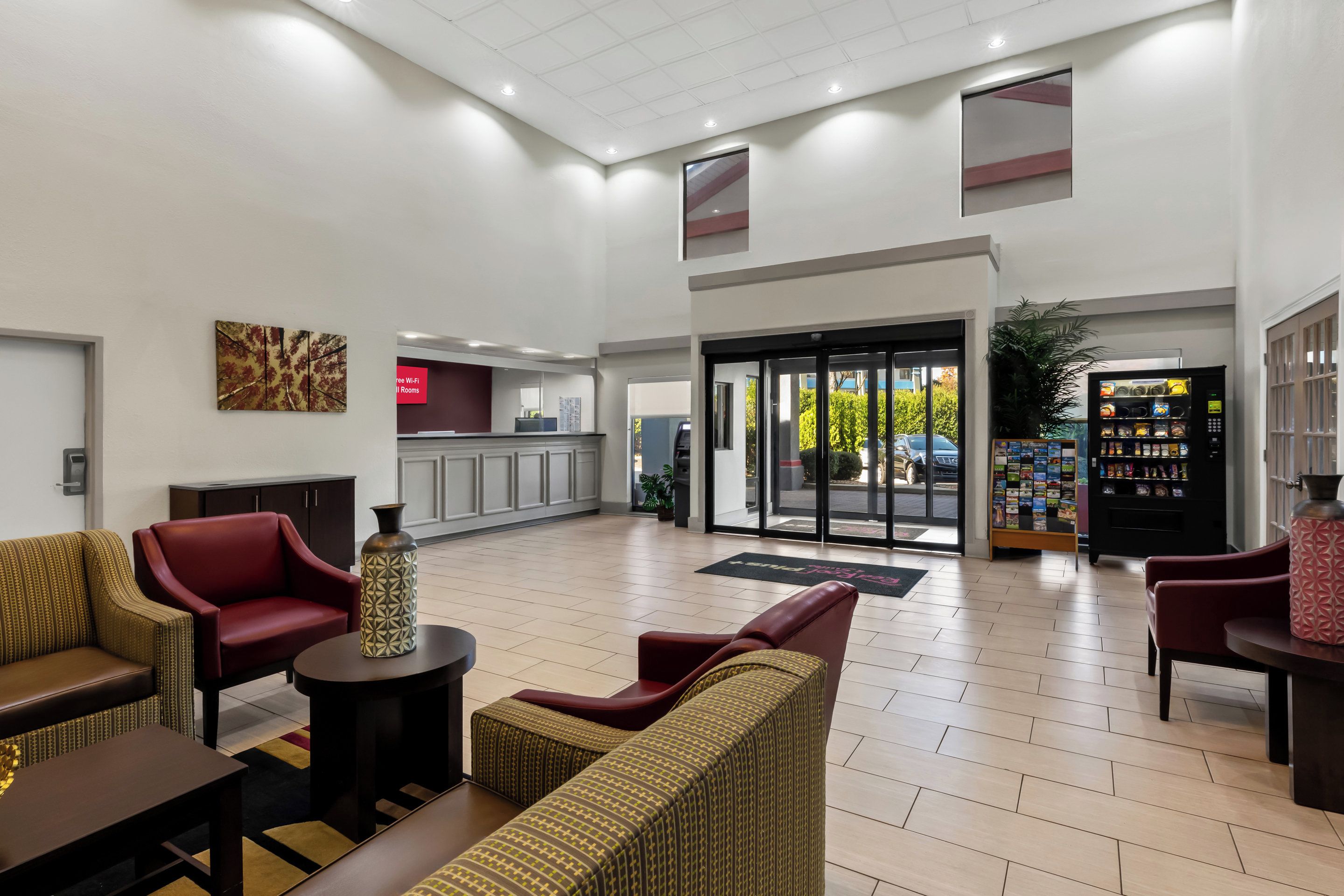A lobby with seating, a reception desk, and a vending machine.