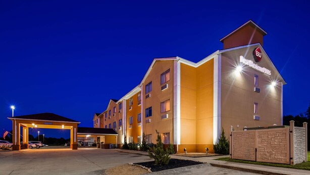 A hotel with a modern design, featuring a prominent 'BW' sign on the facade, multiple windows, and a well-lit entrance area. - Best Western Plus Whitewater Inn (Harrison)