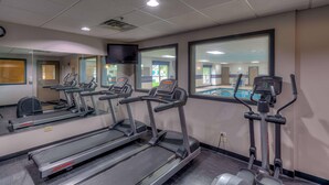 A gym with treadmills, an elliptical, and a mirrored wall. - Country Inn & Suites by Radisson, Crystal Lake, IL (Crystal Lake)