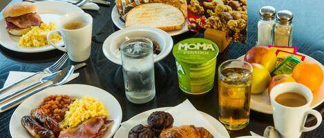 A breakfast buffet with various food items and beverages.