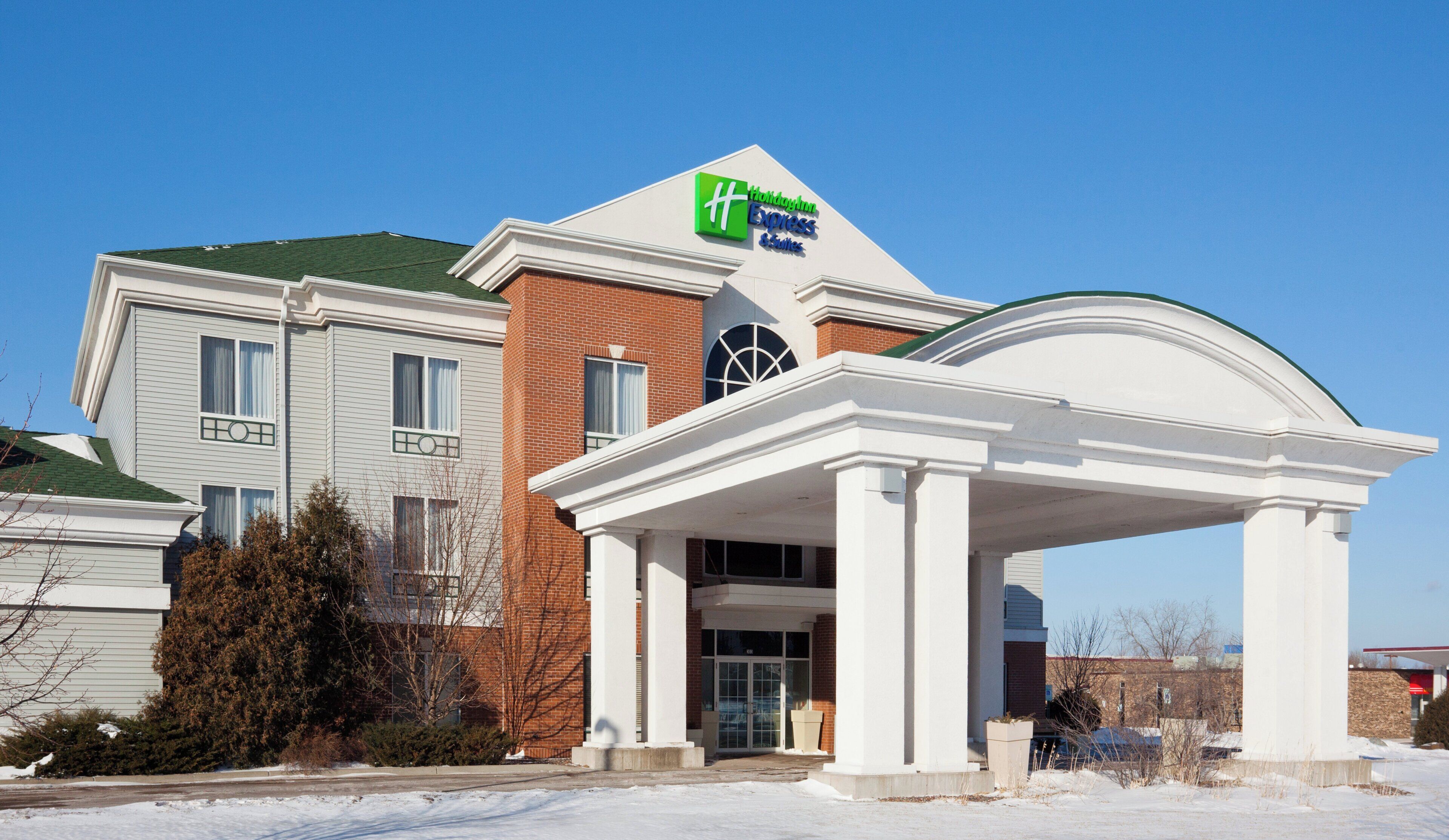 A Holiday Inn Express hotel with a covered entrance and a brick facade.