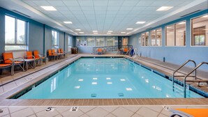 An indoor swimming pool with clear lanes, a changing room, and a seating area with chairs. - Holiday Inn Express Hotel & Suites Greenwood by IHG (Greenwood)