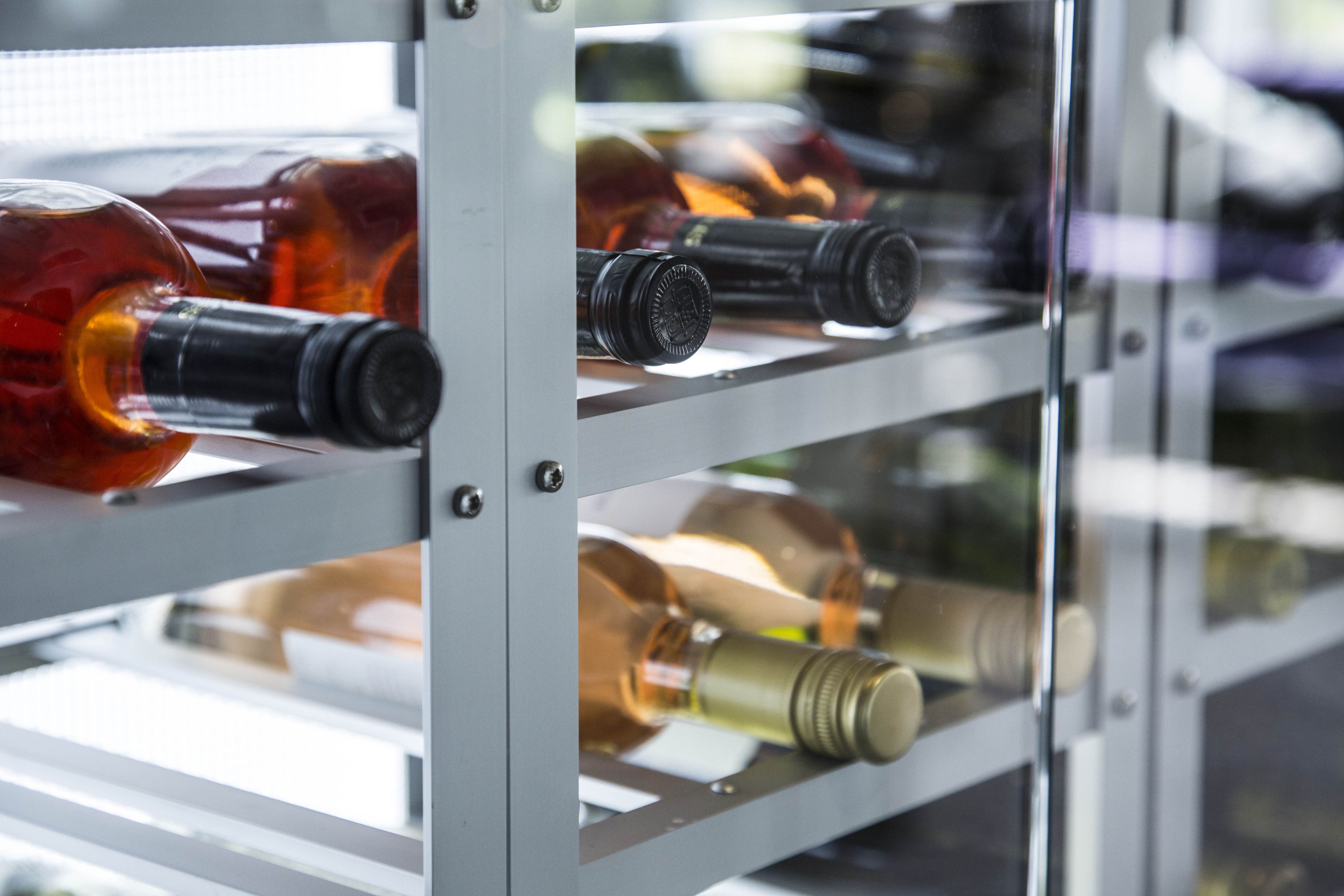A rack of wine bottles in a storage area.