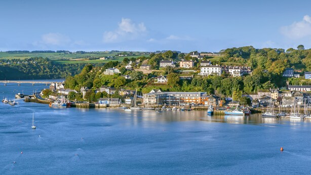 A coastal town with a marina, houses, and a bridge in the background. - Trident Hotel (Kinsale)