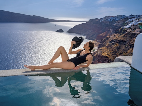 Seasonal outdoor pool, open 11:00 AM to 7:00 PM, pool umbrellas