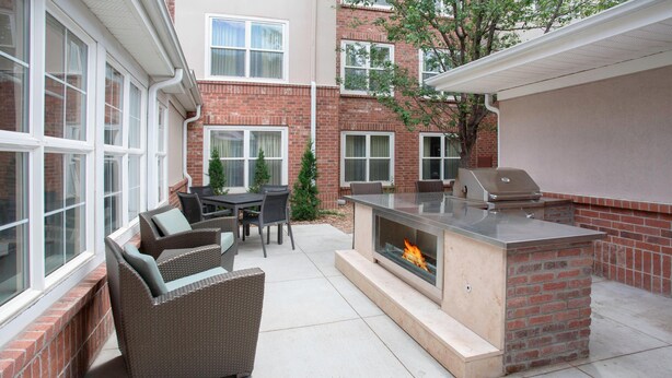 An outdoor patio with a grill, seating area, and a fire feature. - Residence Inn by Marriott Denver Golden/Red Rocks (Golden)
