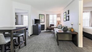 A hotel room with a bed, a desk, a chair, a sofa, a television, and a lamp. - Residence Inn by Marriott Denver Golden/Red Rocks (Golden)