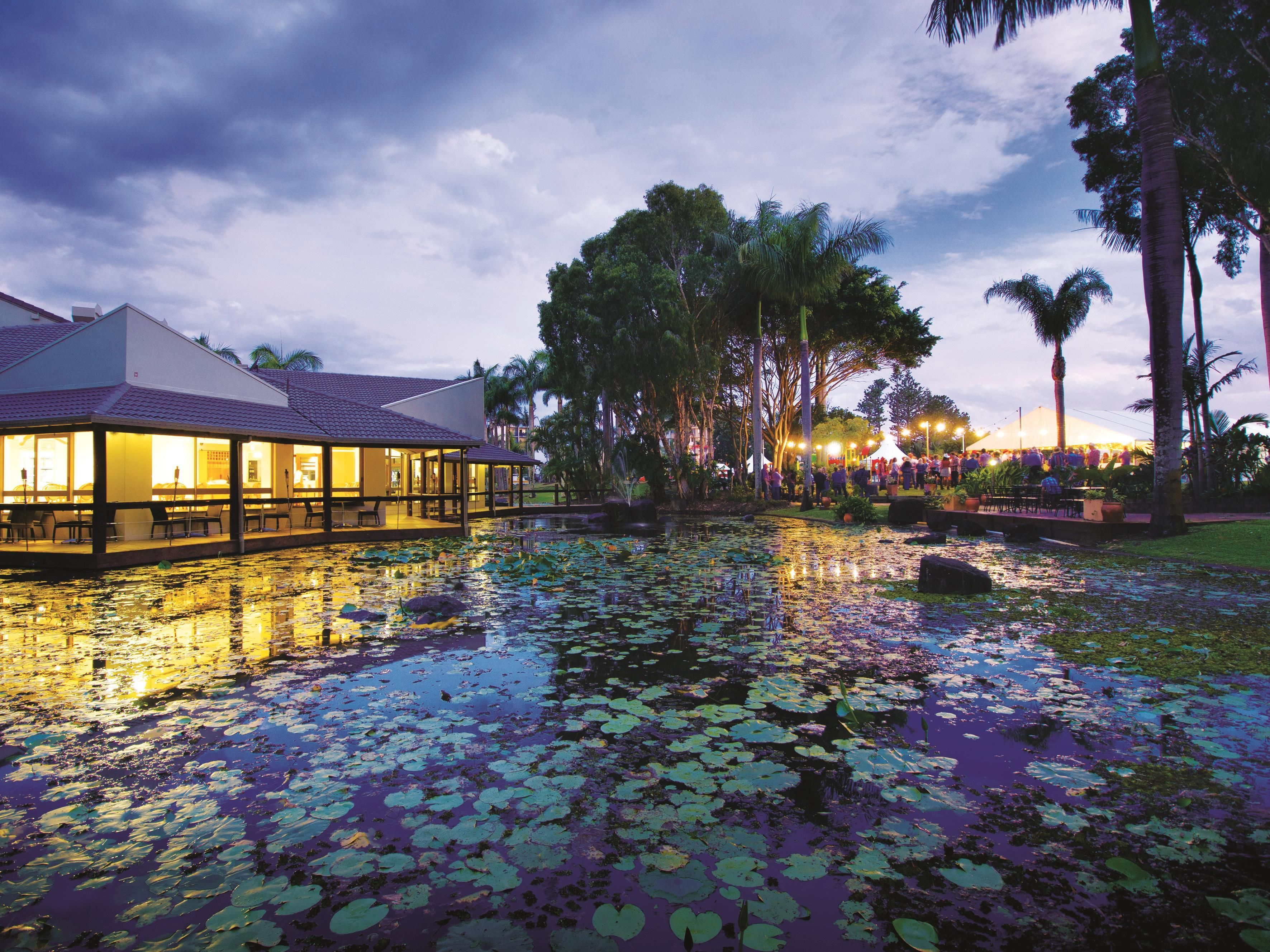 A hotel with a water feature and a dining area.