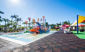 A water park area with a pool, slides, and a small ice cream stand. - Oaks Sunshine Coast Oasis Resort (Golden Beach)