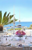 A table set for a meal with a view of the ocean.
