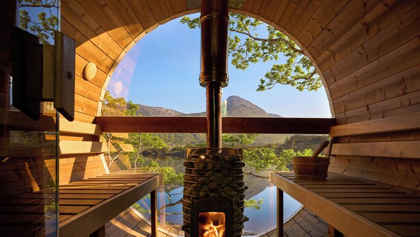A wood-burning stove in a cabin with a view of a lake and mountains. - Ballynahinch Castle Hotel (Ballynahinch)