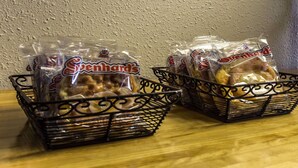 Two black wire baskets containing packaged snacks labeled 'Svenhards'.