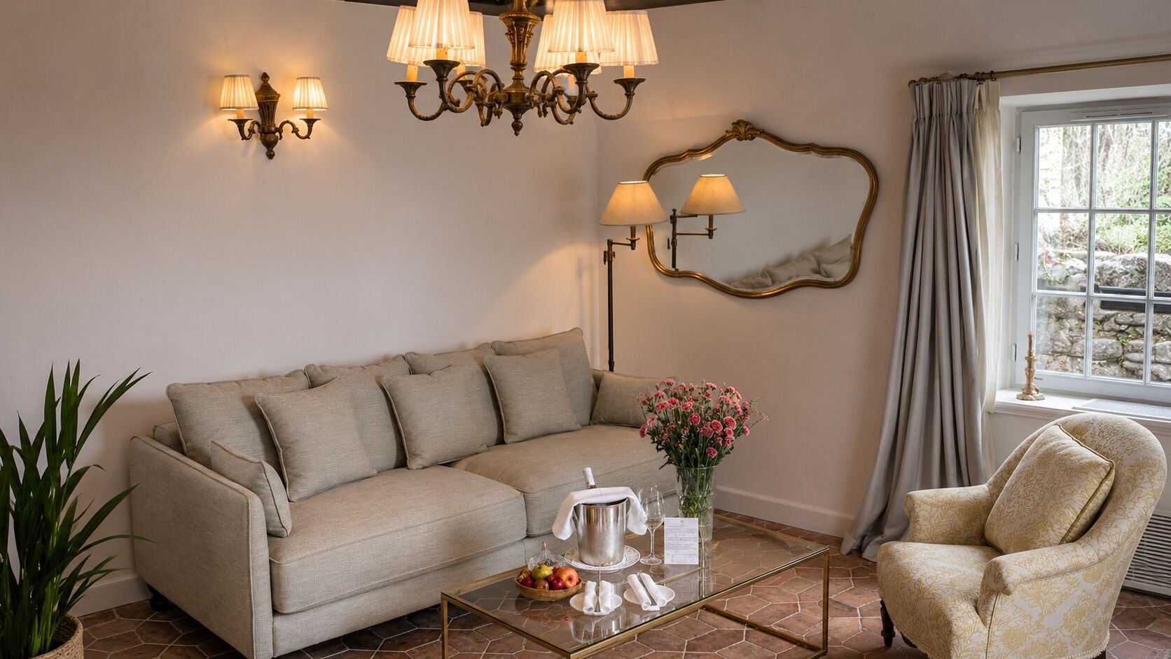 A living room with a sofa, armchair, coffee table, and decorative lamps.