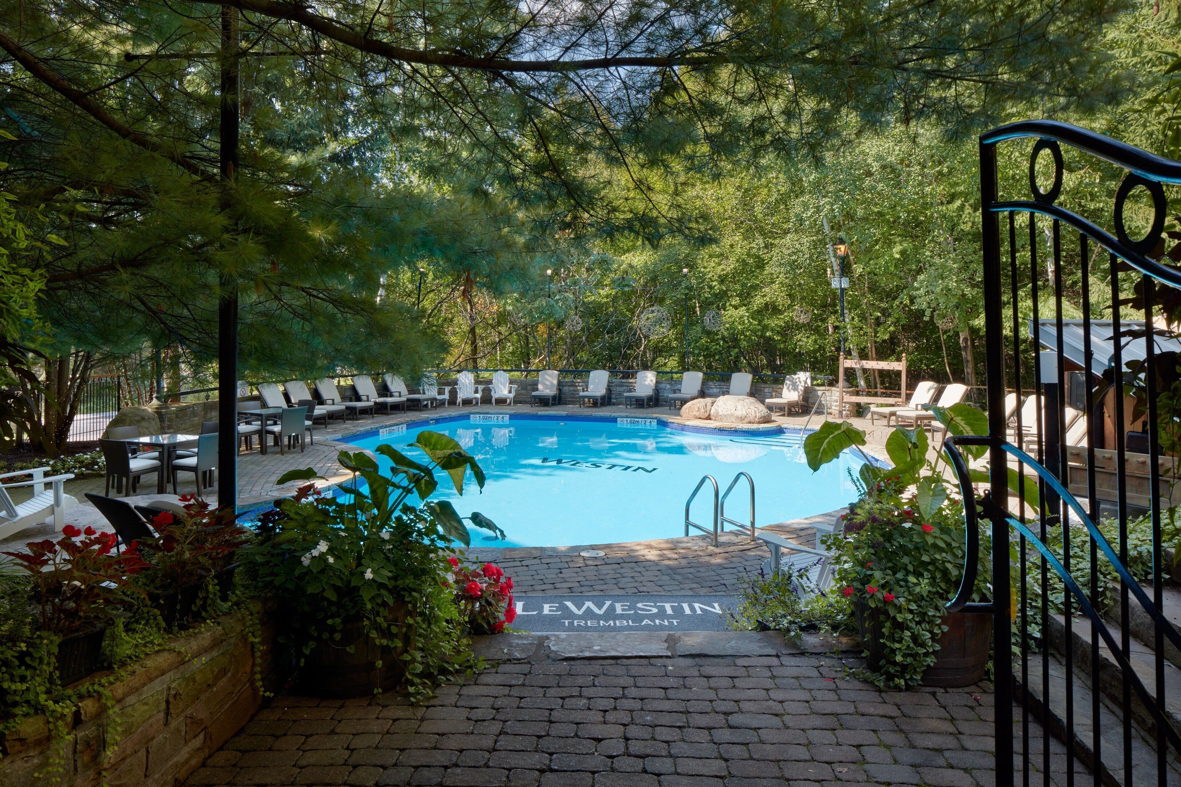outdoor pool, a heated pool, open noon to 8:00 pm, pool loungers