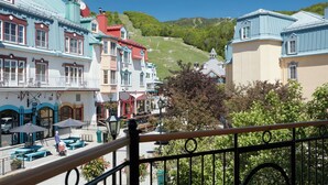 A colorful building with a balcony and outdoor seating area. - Le Westin Tremblant (Mont-Tremblant)