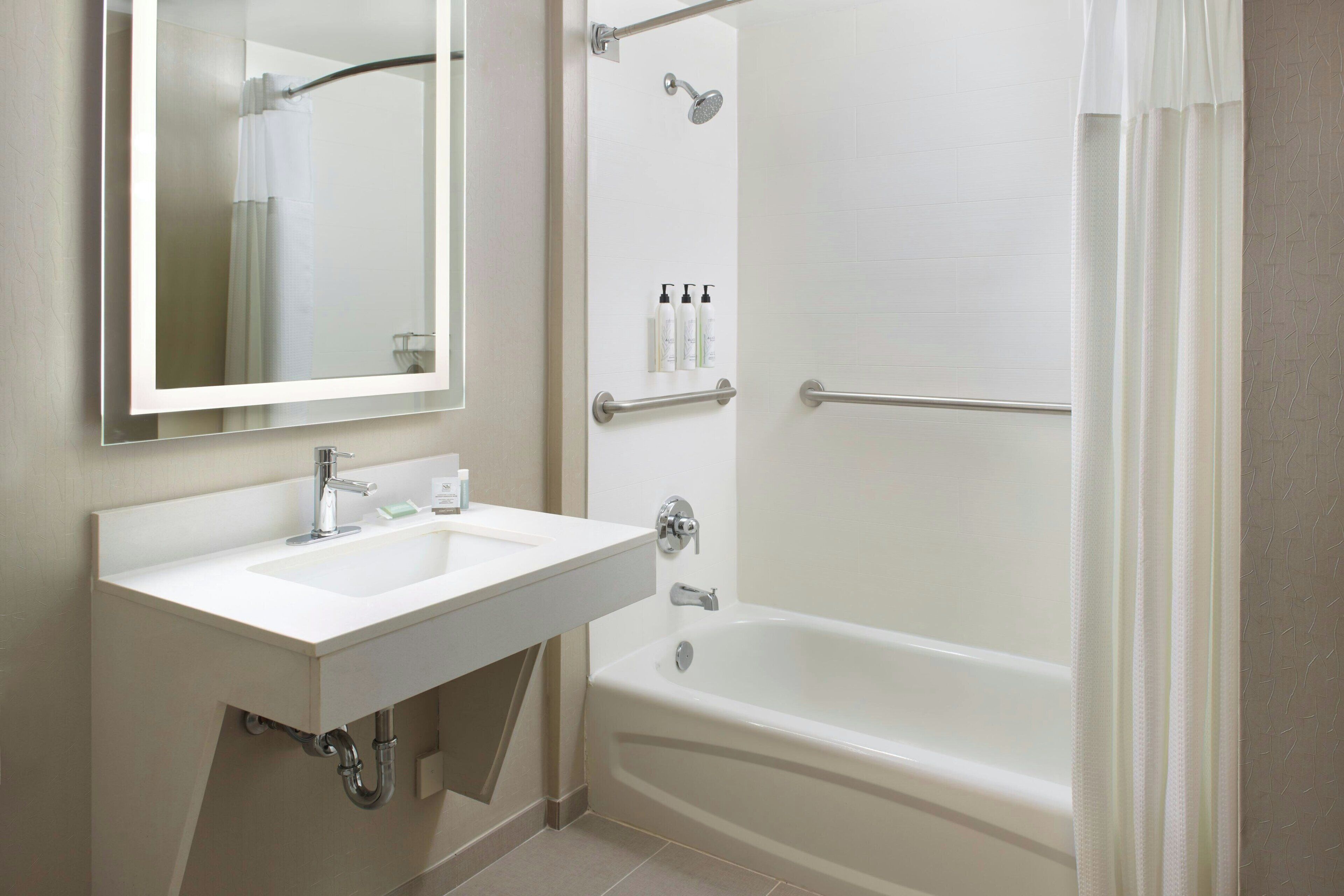 combined shower/bathtub, designer toiletries, hair dryer, towels