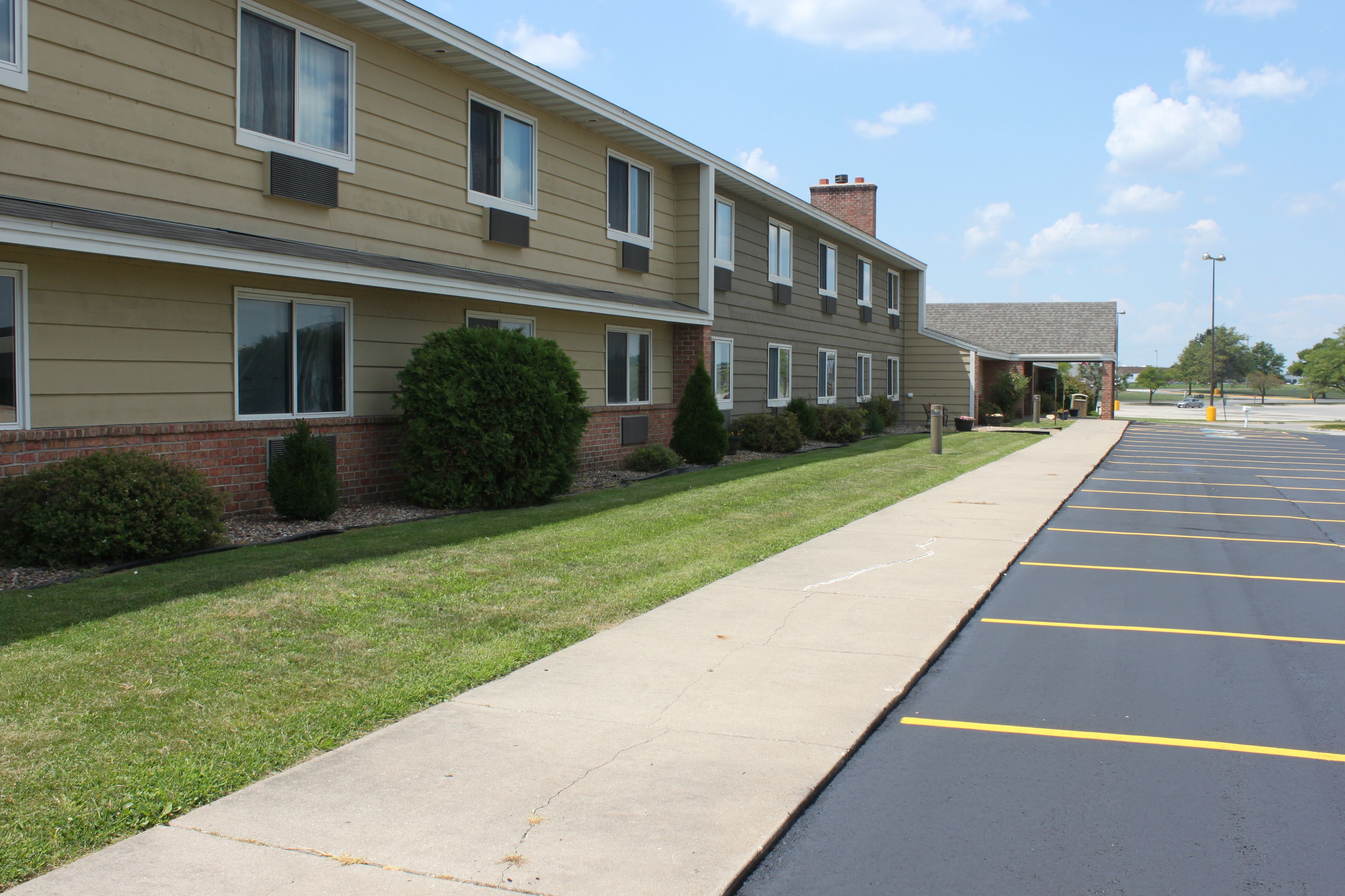 A multi-story building with a parking lot.