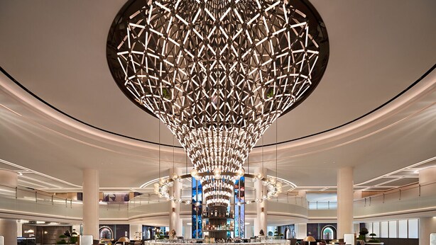 A spacious lobby with a central bar area, high ceilings, and a modern geometric chandelier. - Renaissance Shanghai Hongqiao (Shanghai)