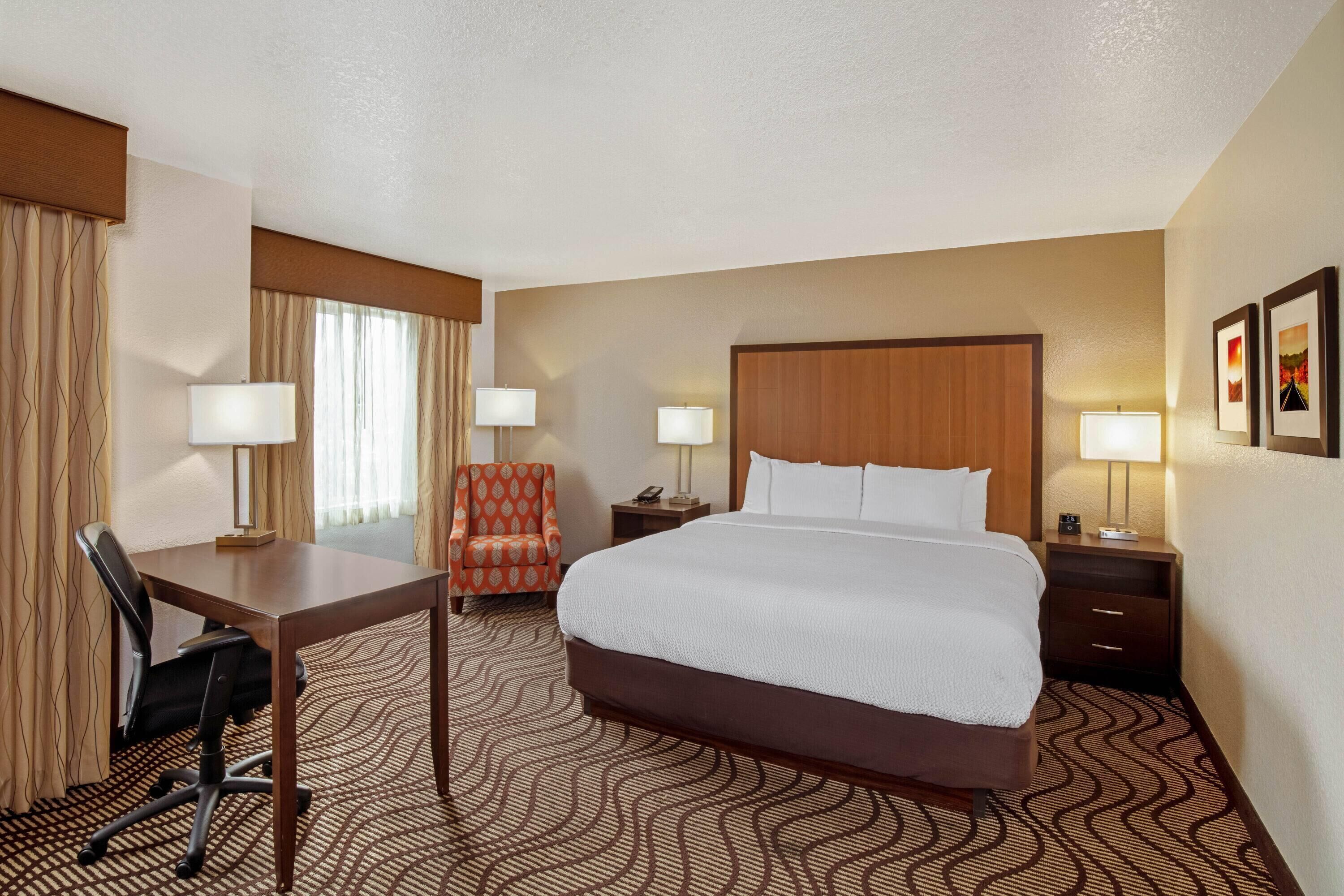 Premium bedding, desk, laptop workspace, blackout drapes
