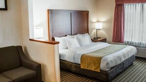 A hotel room with a bed, bedside tables, a desk, a chair, and a window with curtains. - Comfort Suites Portland Southwest (Portland)