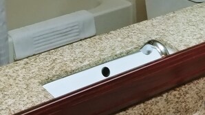 A bathroom with a glass-enclosed shower, a toilet, and a sink with a granite countertop. - Comfort Suites Portland Southwest (Portland)
