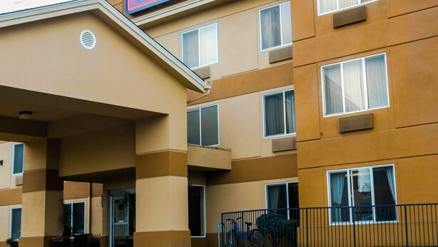 A multi-story hotel with a sign reading "Comfort Suites." - Comfort Suites Portland Southwest (Portland)