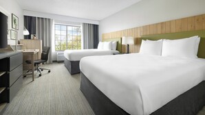 A hotel room with two beds, a desk, a chair, and a window with curtains. - Country Inn & Suites by Radisson, Springfield, OH (Springfield)