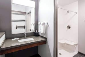 A bathroom with a sink, mirror, towel rack, and a shower area. - Courtyard by Marriott Denver Golden/Red Rocks (Golden)