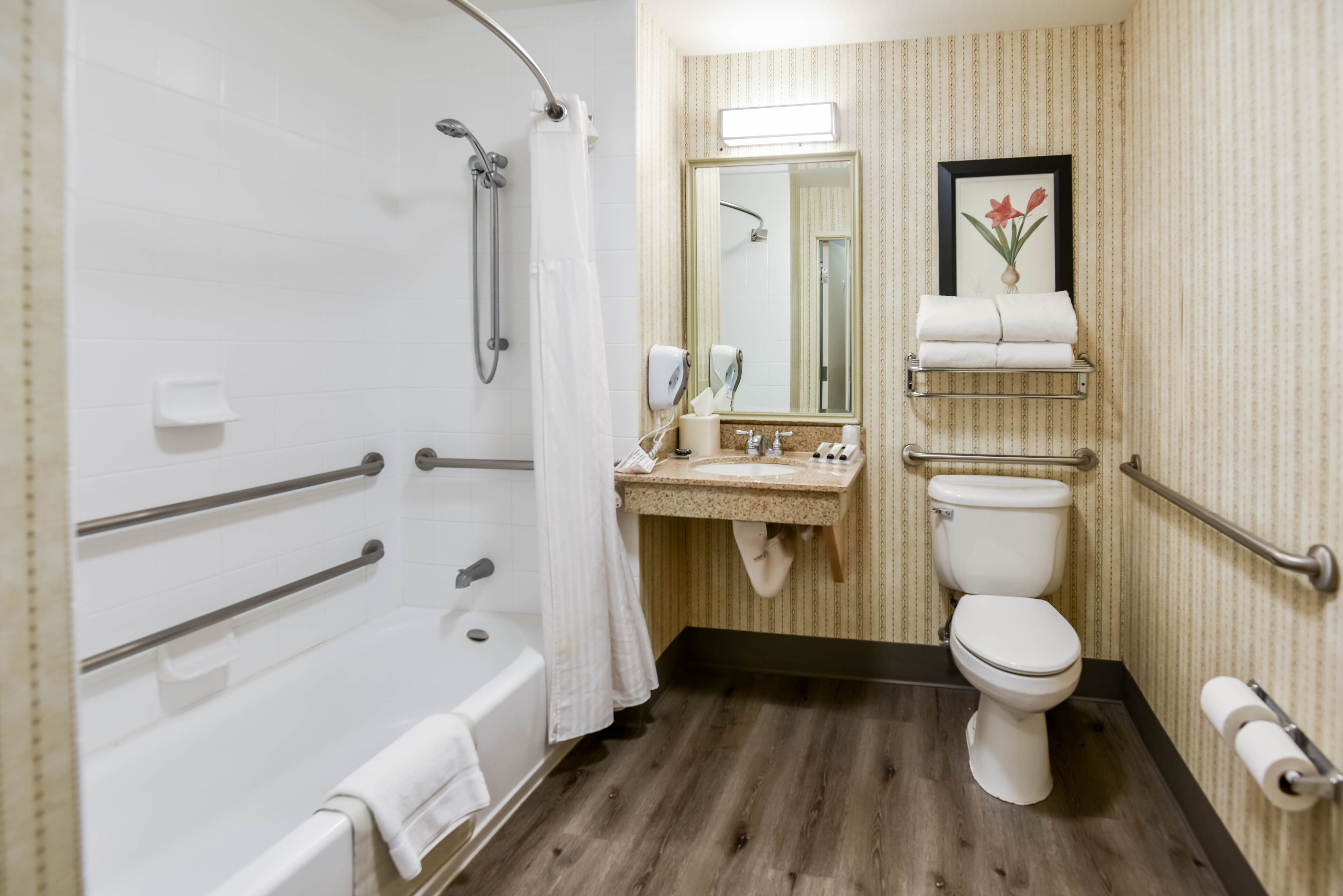 A bathroom with a bathtub, toilet, and sink.