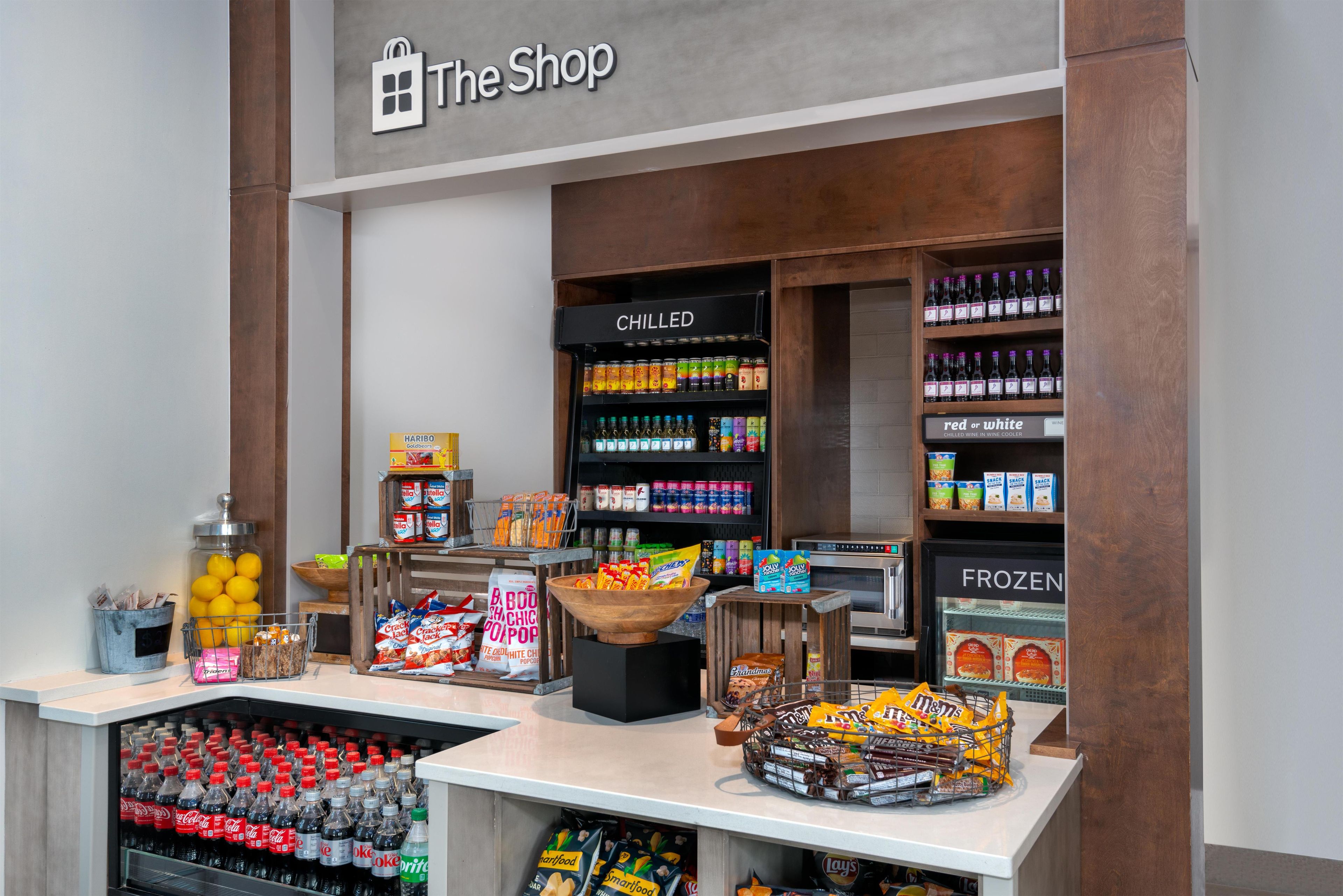 A store interior with a variety of snacks, beverages, and a refrigerated section labeled 'CHILLED'.