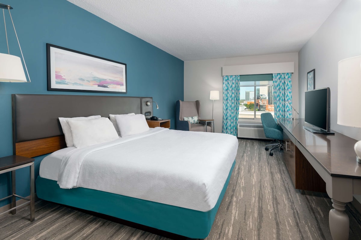 Premium bedding, desk, laptop workspace, blackout curtains