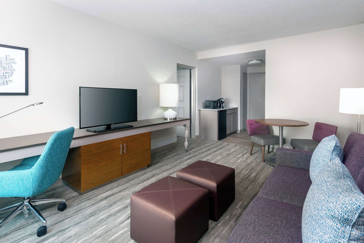 Premium bedding, desk, laptop workspace, blackout curtains