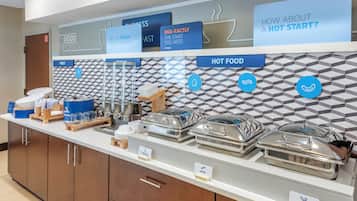 A buffet setup with labeled food sections including 'GOOD MORNING', 'FEELIN' FRESH THIS MORNING', 'EGG-XACTLY THE START YOU NEED', 'HOT FOOD', and 'PORK SAUSAGE'.
