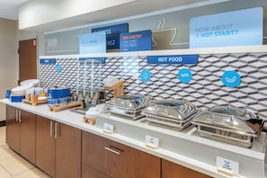 A buffet setup with labeled food sections including 'GOOD MORNING', 'FEELIN' FRESH THIS MORNING', 'EGG-XACTLY THE START YOU NEED', 'HOT FOOD', and 'PORK SAUSAGE'. - Holiday Inn Express Hotel & Suites Cincinnati-Blue Ash by IHG (Cincinnati)