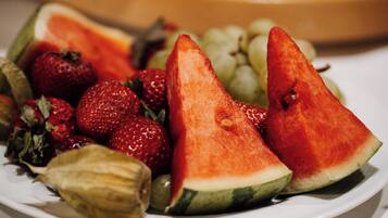 A plate of sliced watermelon, strawberries, and grapes.