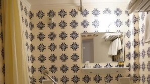 A bathroom with a toilet, sink, and shower area. - Balasca Hotel (Athens)