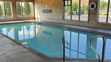 Relax by the pool with a view of the surrounding area through large windows.