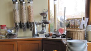 A buffet with various food items including meats, cheeses, and fruits. - Landhotel Dresden (Dresden)