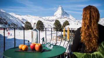 Guests can enjoy a meal with a mountain view from this dining area.