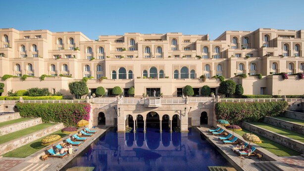 A large hotel with a central pool, multiple balconies, and lush landscaping. - The Oberoi Amarvilas, Agra (Agra)