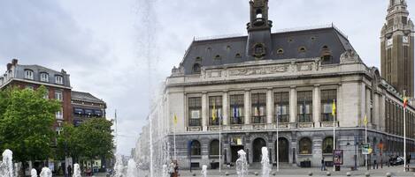 A historic building with a fountain in front.