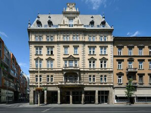 A historic building with a central entrance, large windows, and a symmetrical facade.