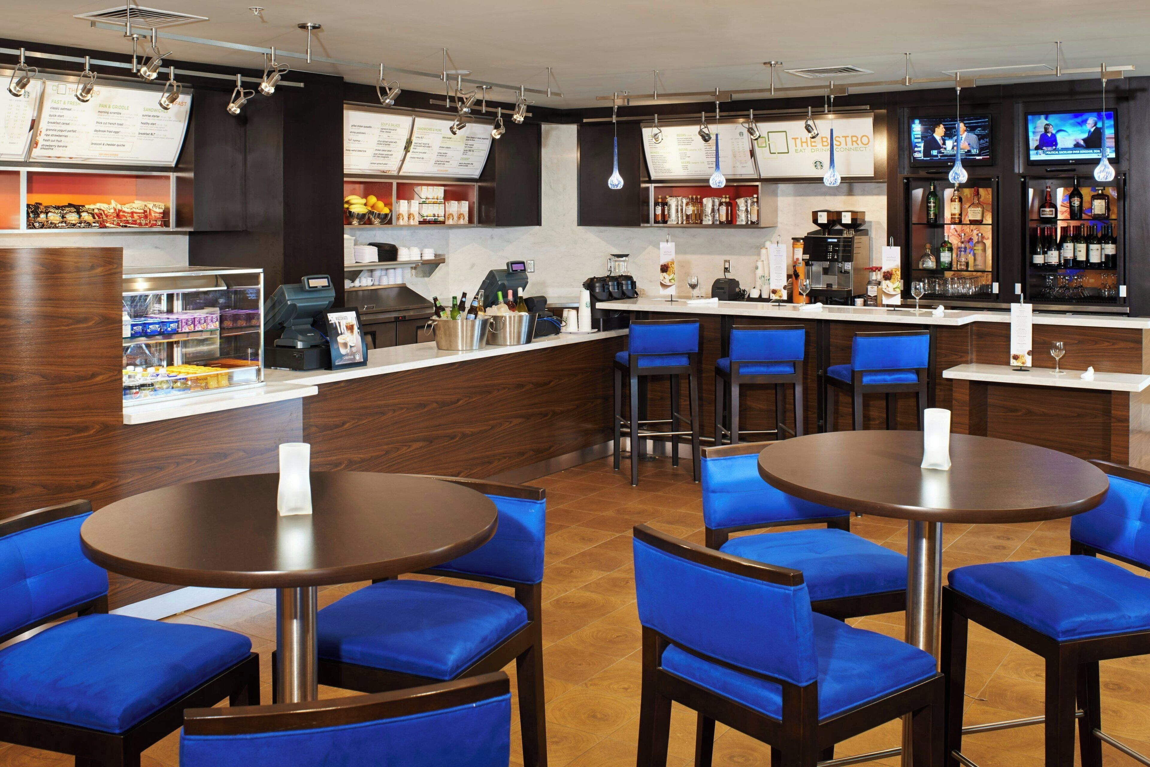 A restaurant with a bar area, seating, and a coffee machine.
