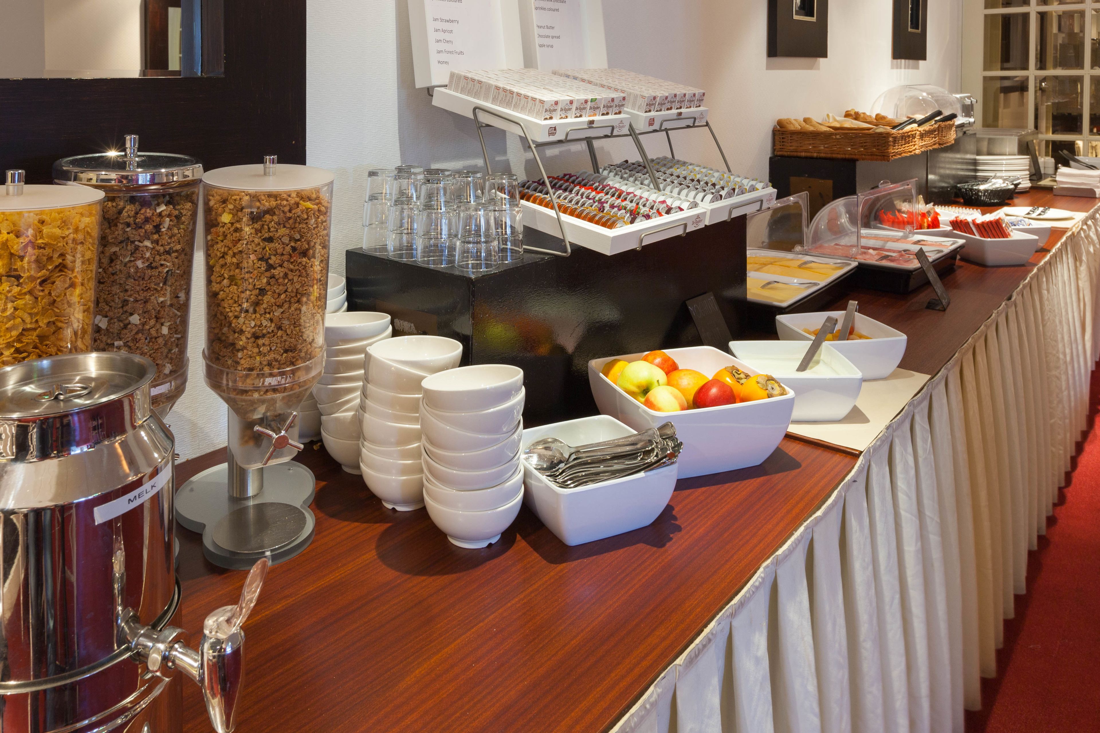 A buffet setup with various food items and beverages.