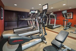 A gym with treadmills, elliptical machines, and a bench. - Fairfield Inn & Suites Tucson North/Oro Valley (Oro Valley)