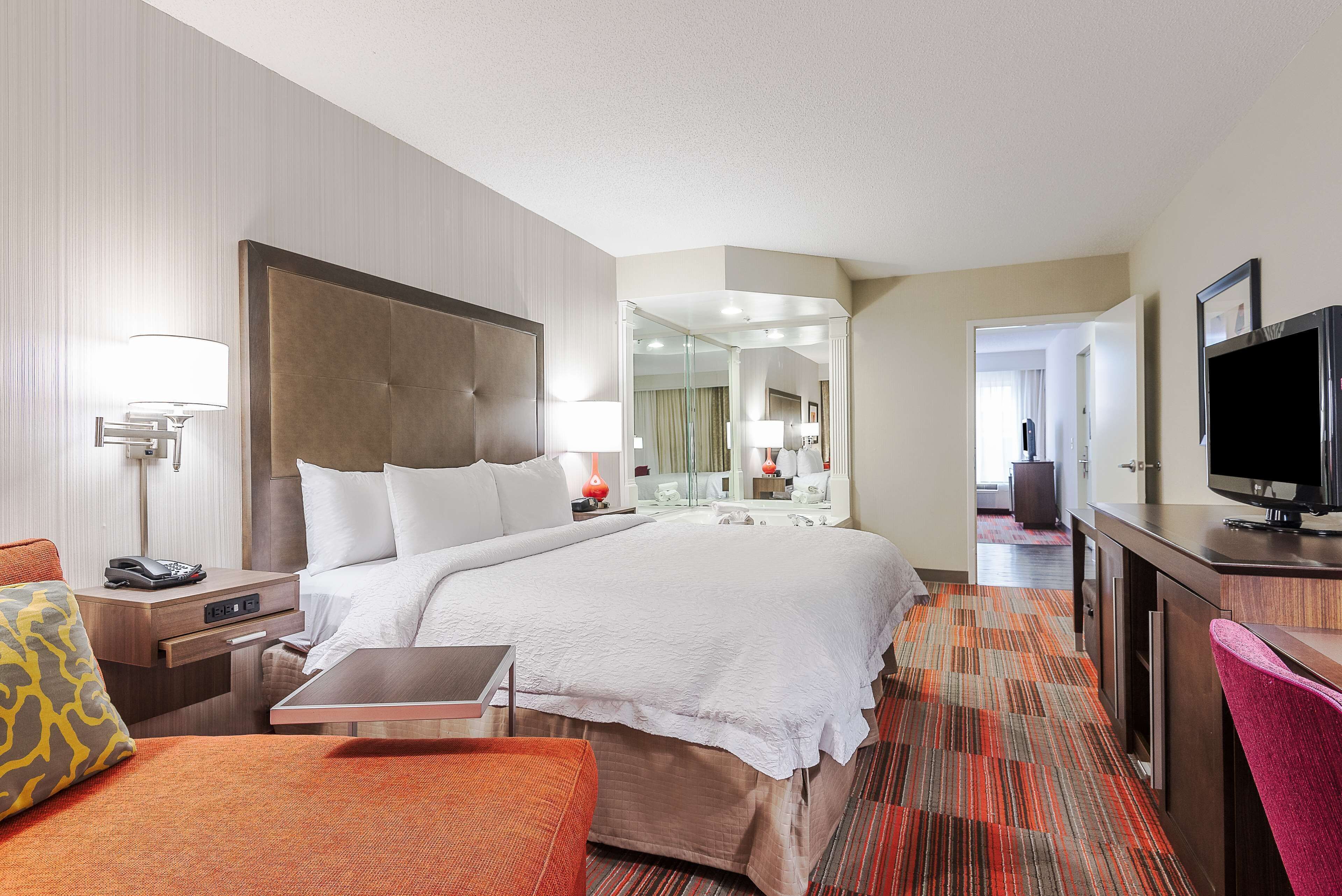 Premium bedding, desk, laptop workspace, blackout drapes