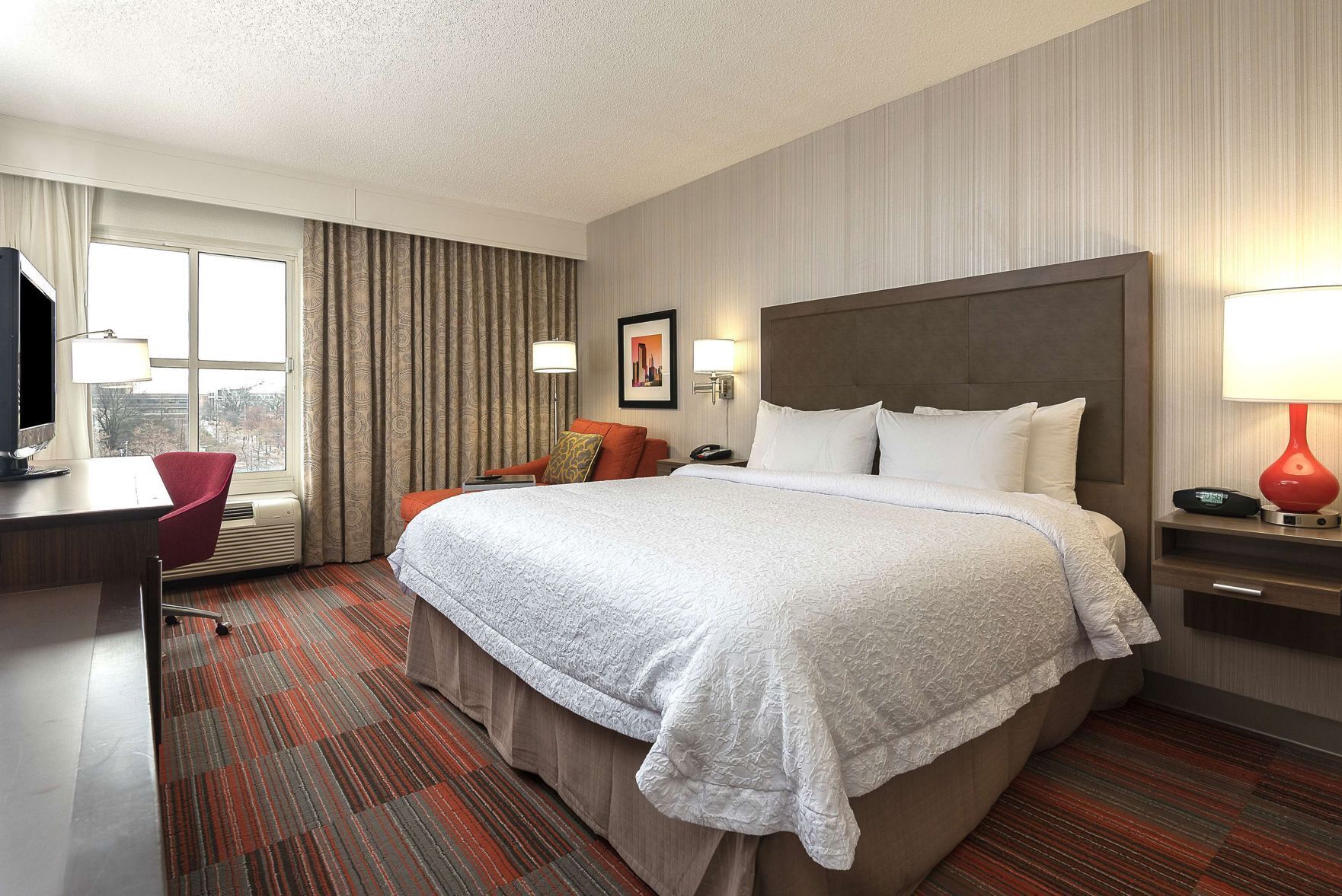 Premium bedding, desk, laptop workspace, blackout drapes